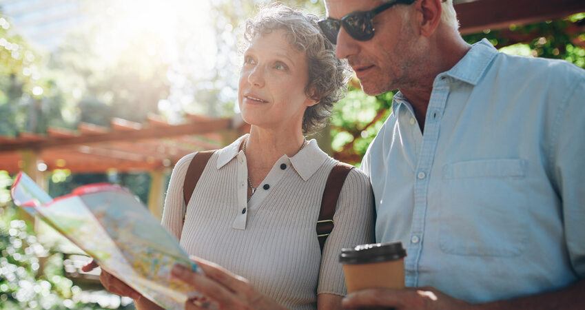 Close up portrait of senior couple using a map for directions. Retired couple exploring new places to visit during their vacation.